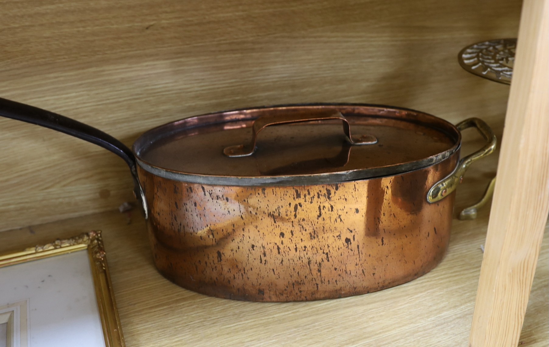 Sundry brass and copper, including a brass fireman’s helmet, a coal helmet, a staved and coopered wood and copper jug, a Victorian brass warming pan, a Victorian copper warming pan, a Victorian brass kettle etc.